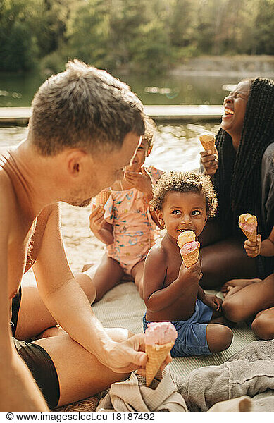 Happy family enjoying eating ice cream during vacation