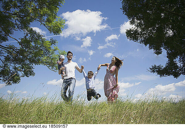 Happy family enjoying on meadow in the countryside  Bavaria  Germany