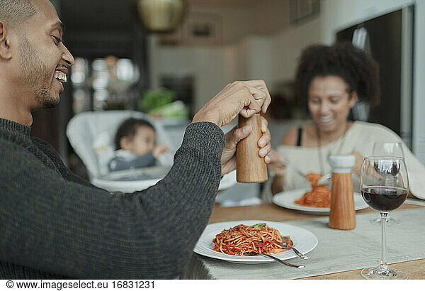 Happy family enjoying spaghetti dinner at dining table