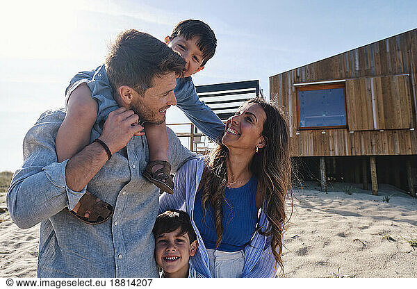 Happy family enjoying together in front of beach house