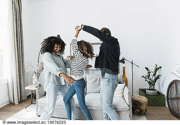 Happy family havin fun dancing together in the living room