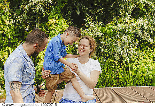 Happy family spending leisure time on footbridge