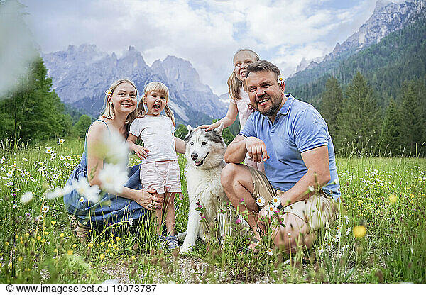 Happy family spending vacation with dog