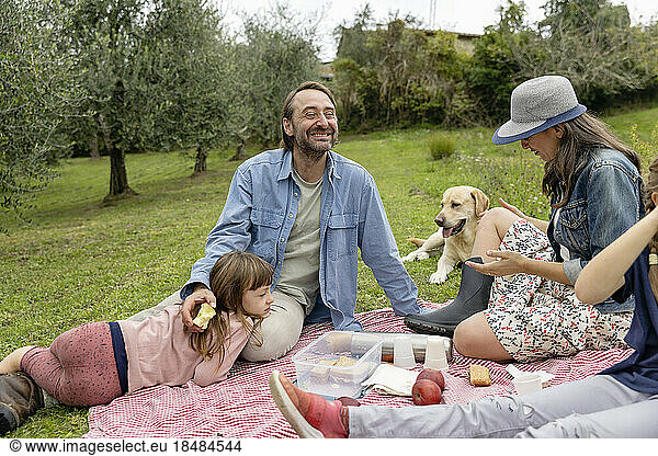 Happy family together having picnic on field