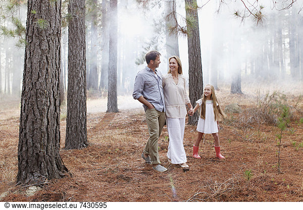 Happy family walking in woods