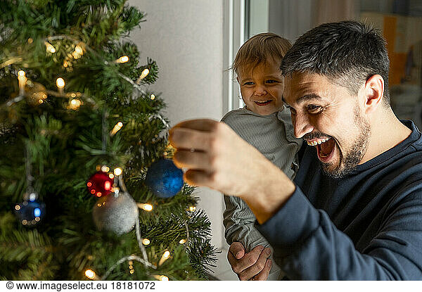 Happy father with son looking at Christmas decoration