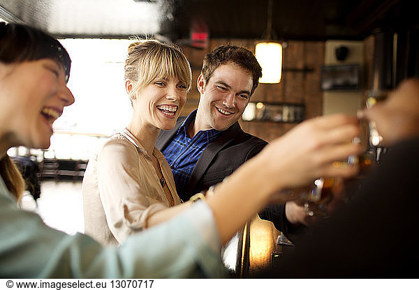 Happy friends enjoying in bar