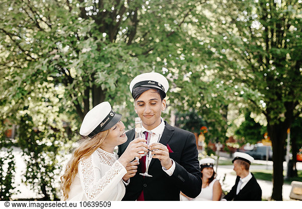 Happy friends toasting champagne at graduation party