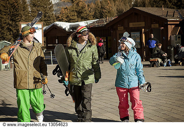 Happy friends walking at ski resort