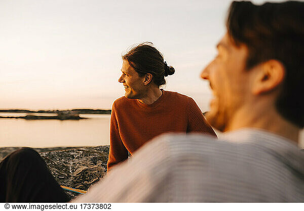 Happy gay couple enjoying at lakeshore during vacation