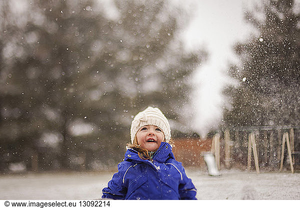 Happy girl enjoying snowfall