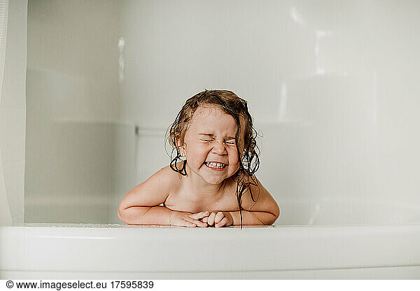 Happy girl with eyes closed in bathtub