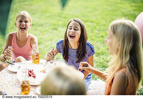 Happy girls having a birthday party outdoors