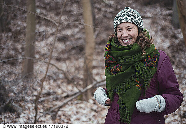 Happy healthy active woman outdoors on walk in winter in europe