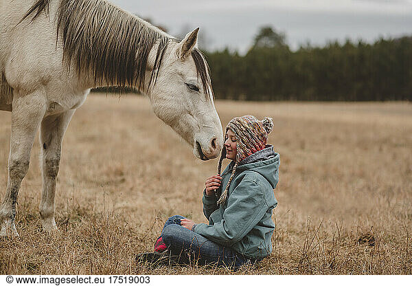 Happy horse in front of teen girl