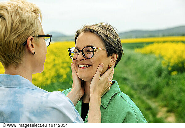 Happy lesbian couple wearing eyeglasses embracing each other