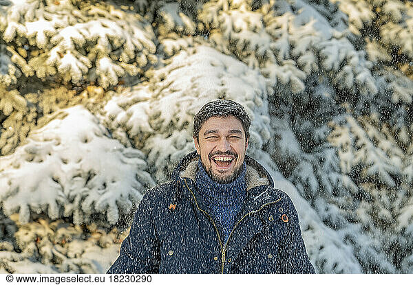 Happy man enjoying in winter park