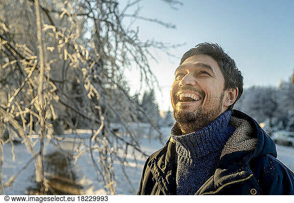 Happy man enjoying winter at park