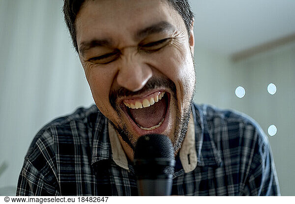 Happy man singing at home