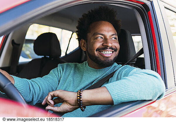Happy man sitting in car