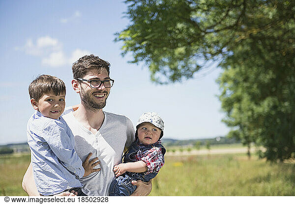 Happy man with his son enjoying picnic in the countryside  Bavaria  Germany