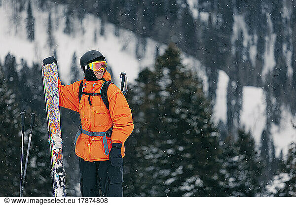 Happy man with skis enjoying winter