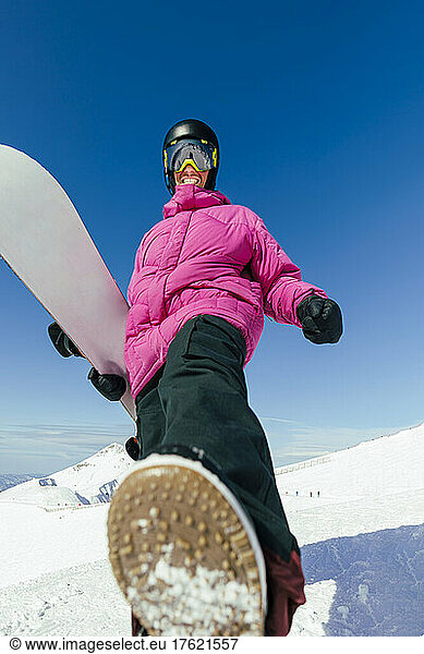 Happy man with snowboard on sunny day