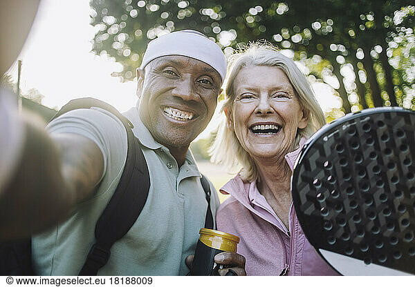 Happy mature man taking selfie with senior woman