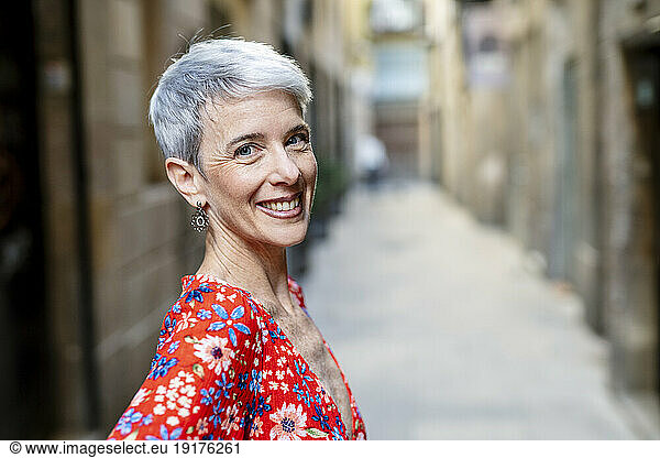Happy mature woman in alley