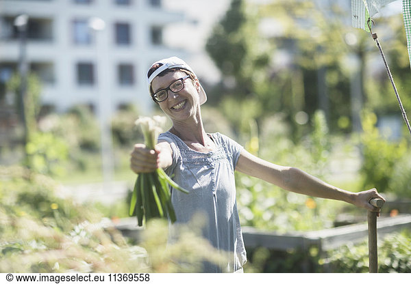 Happy mature woman working in urban garden