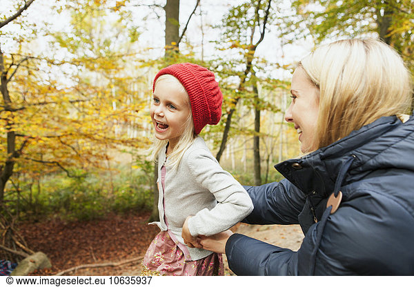 Happy mother and daughter in forest