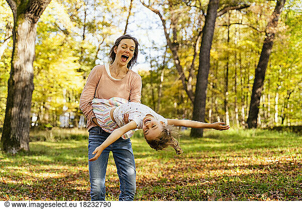 Happy mother with daughter enjoying in park