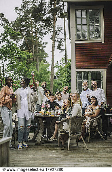 Happy multi-generation family enjoying birthday party on porch