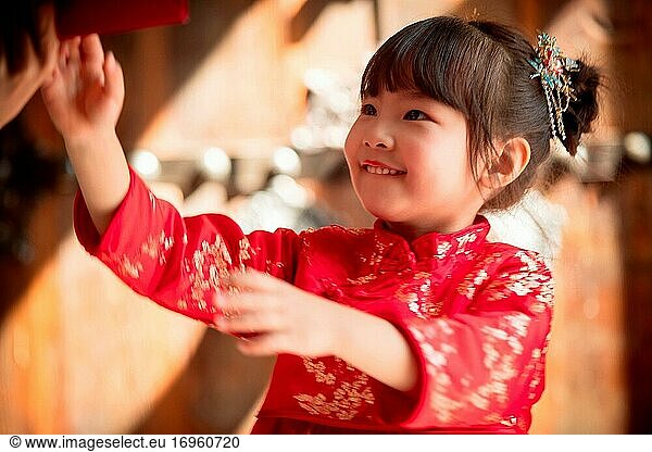 Happy New Year receive red envelopes little girl