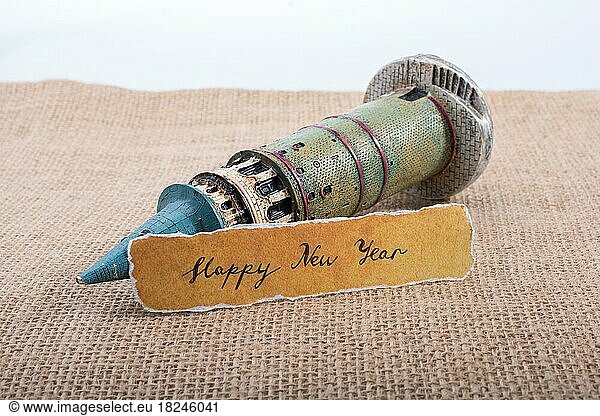 Happy new year written torn paper on Galata Tower model