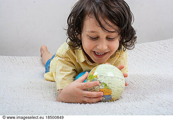 Happy preschooler boy discovering world as back to school concep