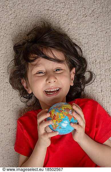 Happy preschooler boy discovering world as back to school concep