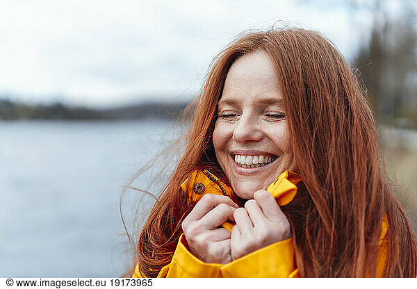 Happy redhead woman with eyes closed