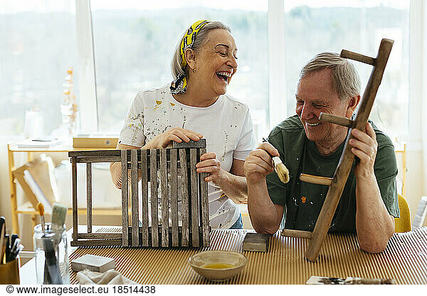 Happy senior couple enjoying together in workshop