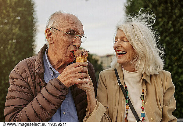 Happy senior couple sharing ice cream