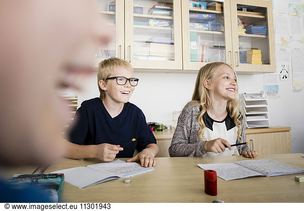Happy students sitting in classroom