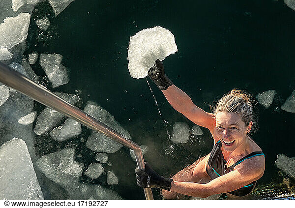 Happy Swimmer Holding Chunk Of Ice From Freezing Water in Copenhagen