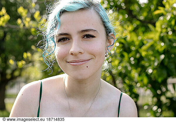 Happy Teen Girl With Blue Hair And Beauty Mark