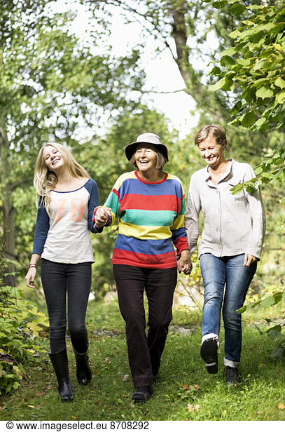 Happy three generation females walking in park