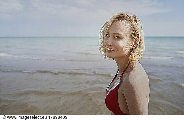 Happy woman at beach on sunny day