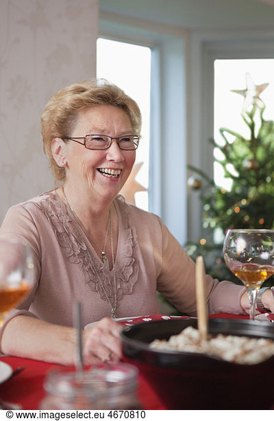 Happy woman at dinner table