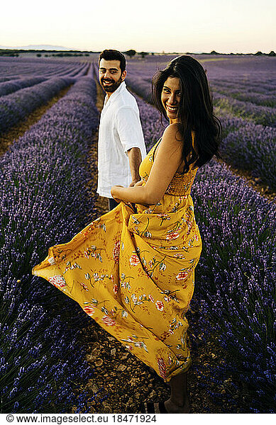 Happy woman enjoying with man in lavender field