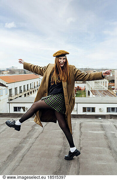 Happy woman having fun dancing on terrace