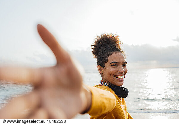 Happy woman having fun in front of sea