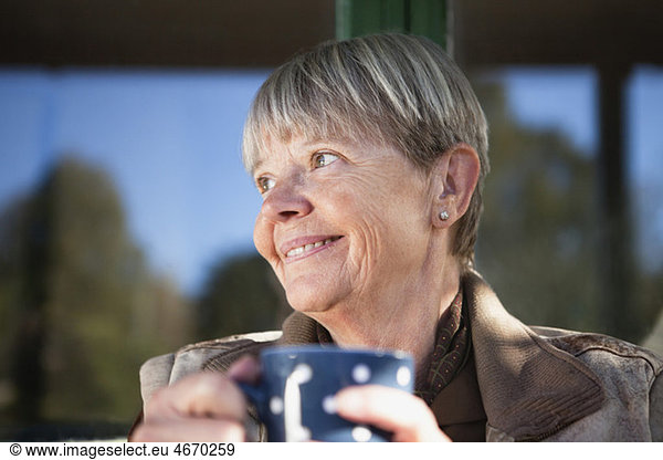 Happy woman holding coffee cup